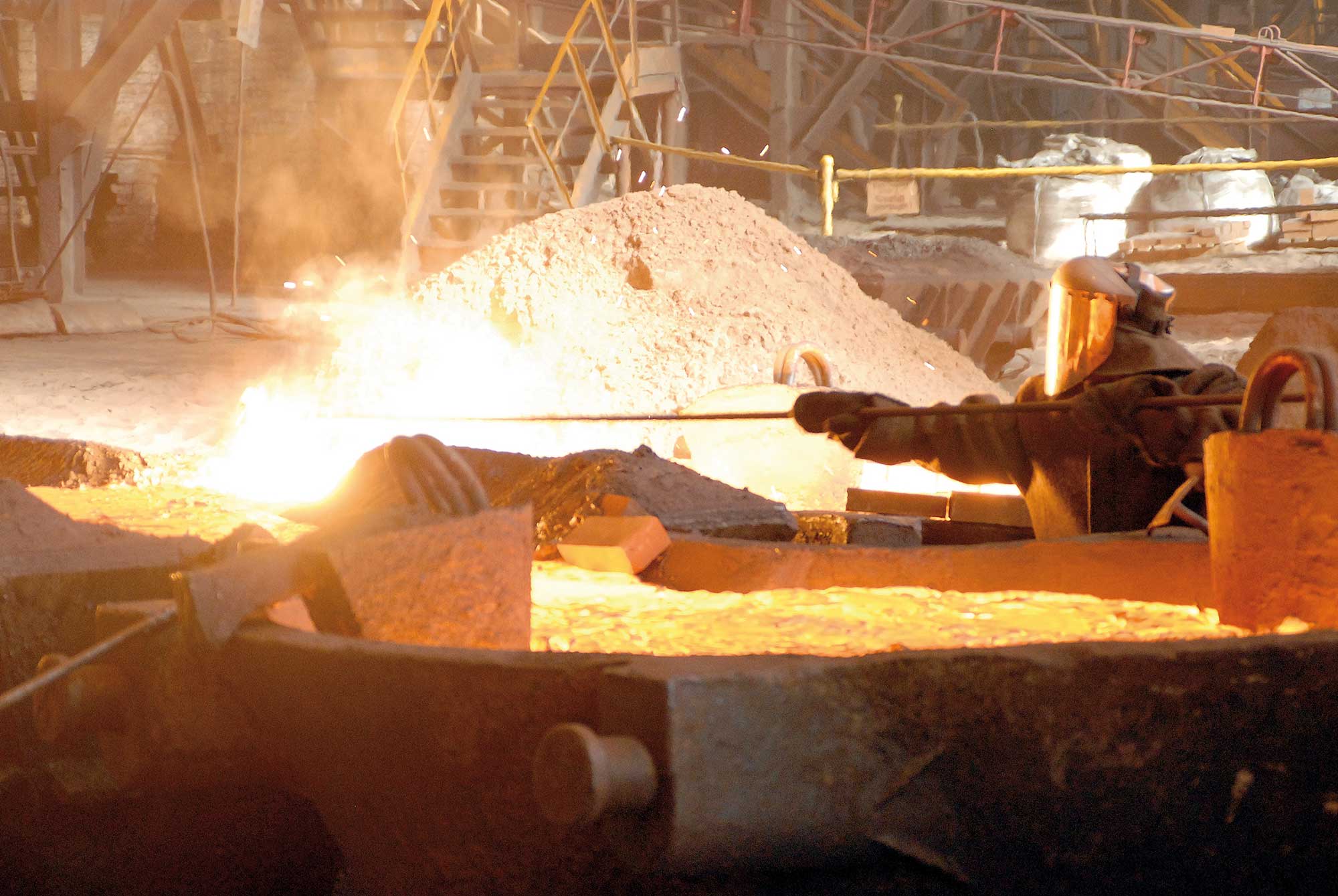 A worker works at a furnace